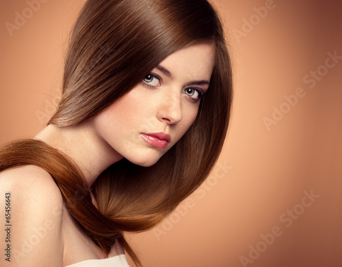 Beauty salon model with perfect long brown hair in studio