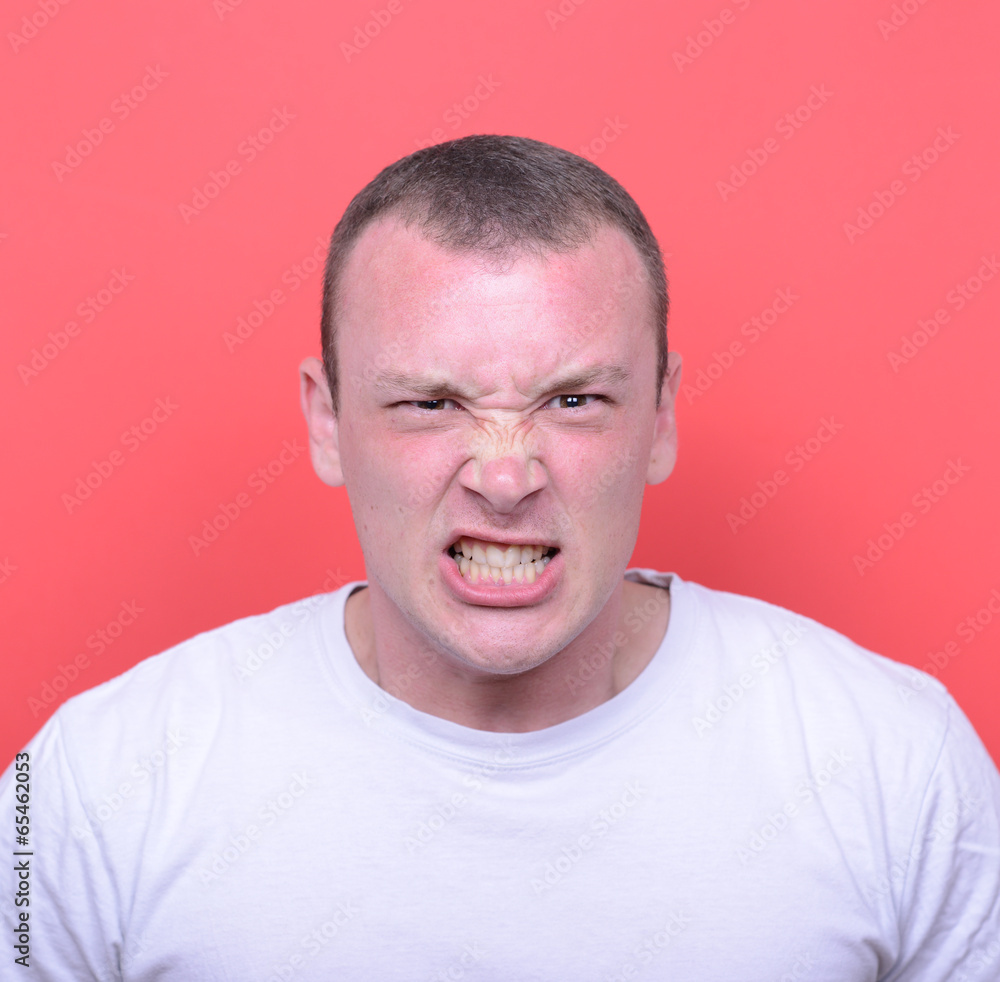 Portrait of angry man screaming and pulling hair against red bac Portrait of angry man screaming and pulling hair against red bac