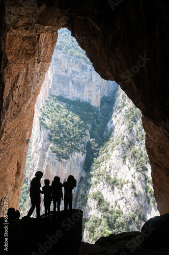 Silhouette children in a Colomera cave, Montsec mountain, Spain photo