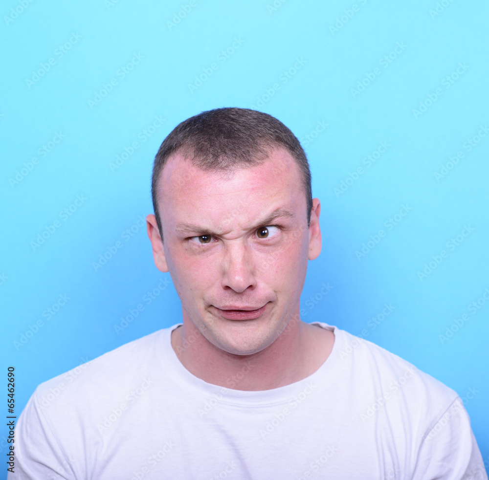Portrait of girl with funny face against blue background Portrait of girl with funny face against blue background