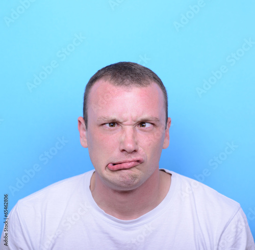 Portrait of girl with funny face against blue background