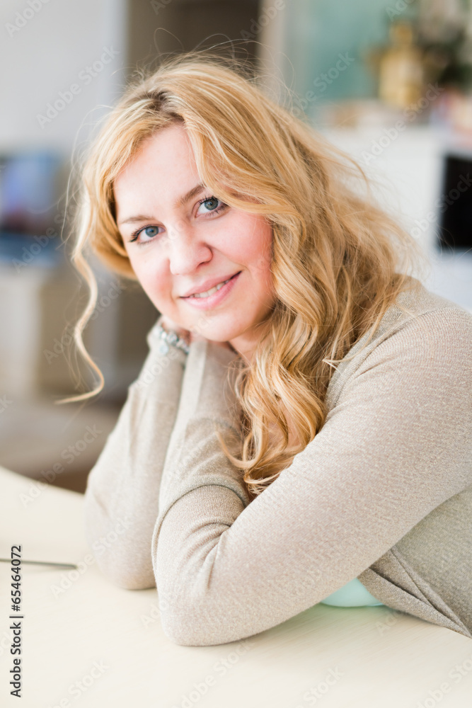 A young woman sitting near table A young woman sitting near table