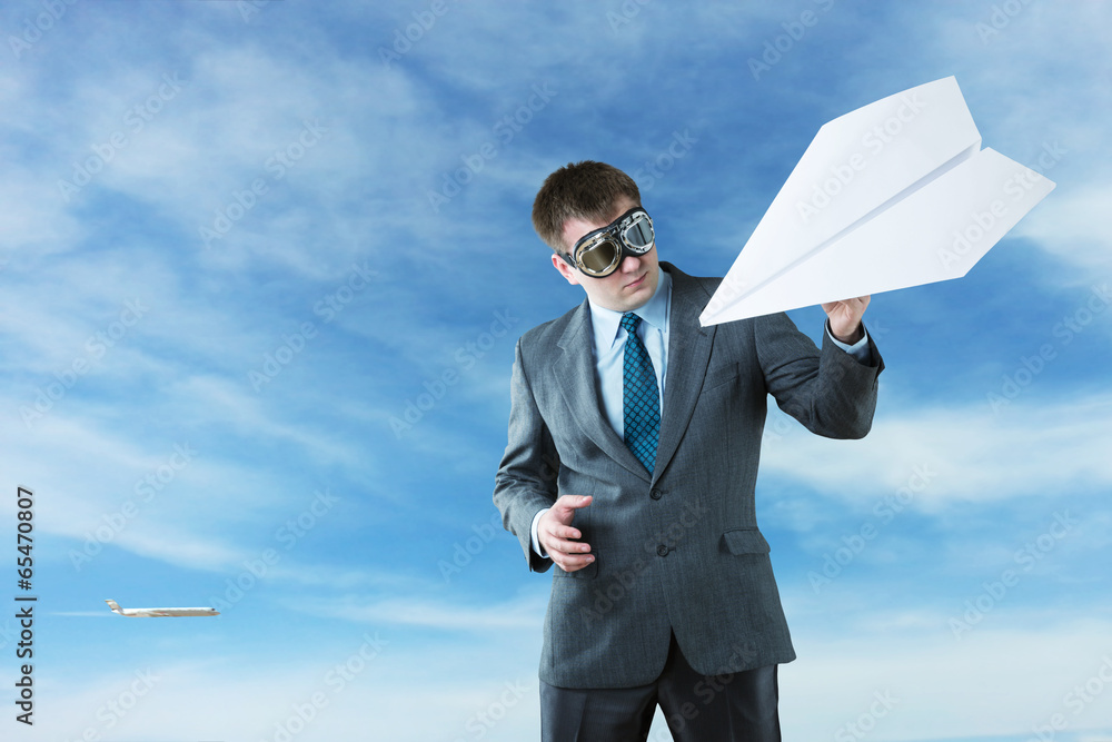 Businessman with paper plane and goggles Businessman with paper plane and goggles