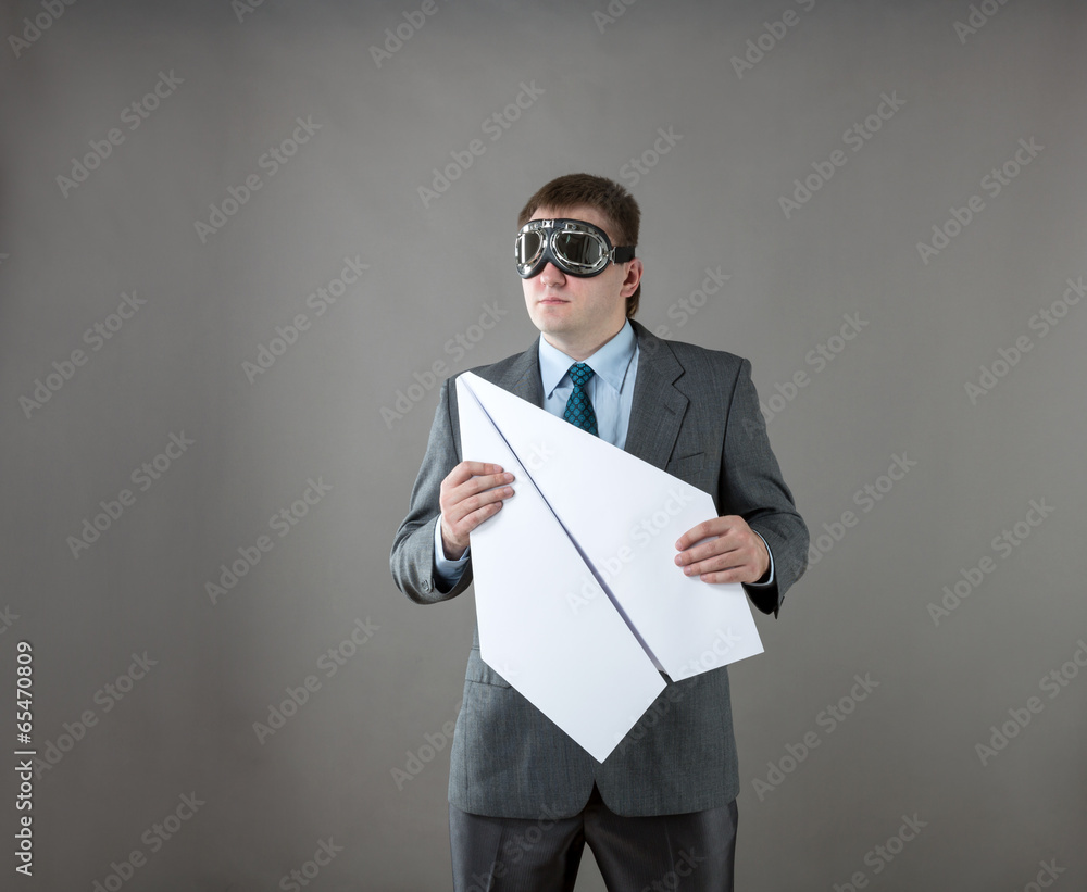 Businessman with paper plane and goggles