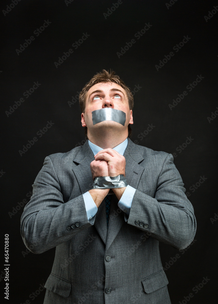 Man with mouth covered by masking tape Man with mouth covered by masking tape