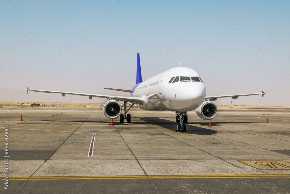 The plane is on the runway at the airport runway