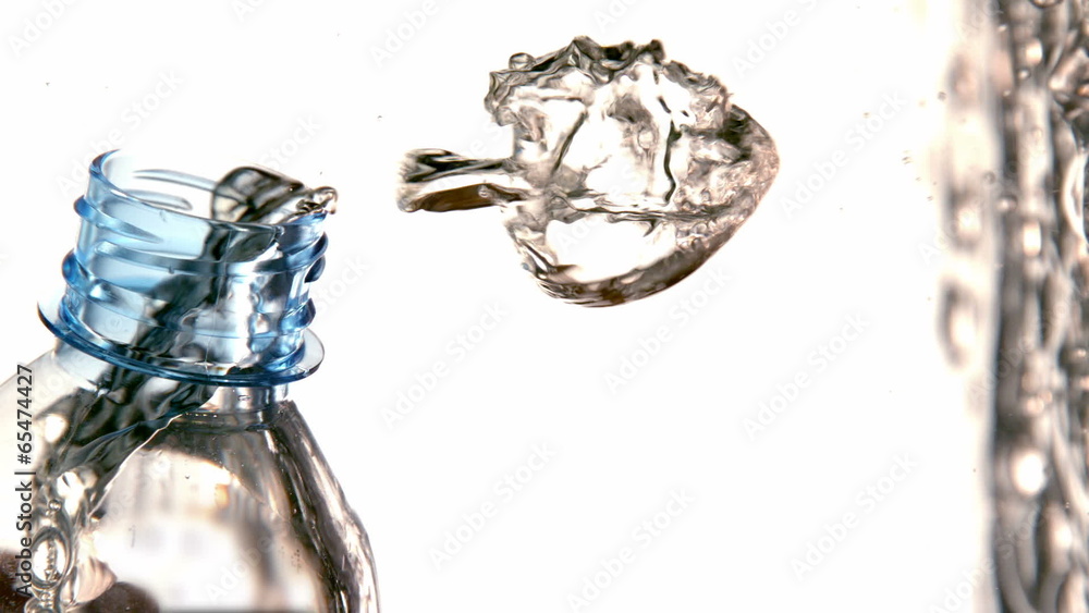 Bubbles floating out of bottle in water on white background