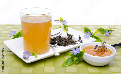 Cup of tea with honey and flowers