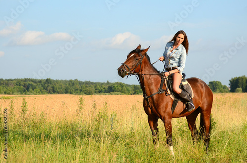 The woman on a horse in the field