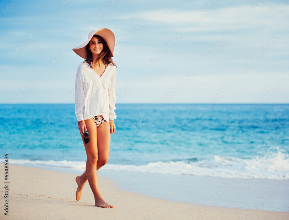 Beautiful young woman walking on tropical beach Beautiful young woman walking on tropical beach