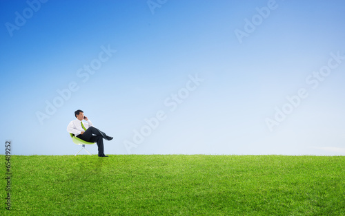 Business Man Sitting And Talking On The Phone Outdoors
