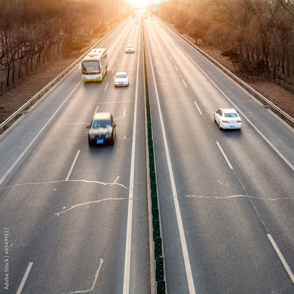 Cars in motion blur on street during sunset Cars in motion blur on street during sunset