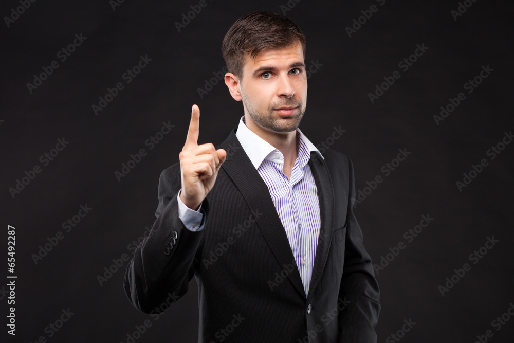 Young businessman in a black suit Young businessman in a black suit