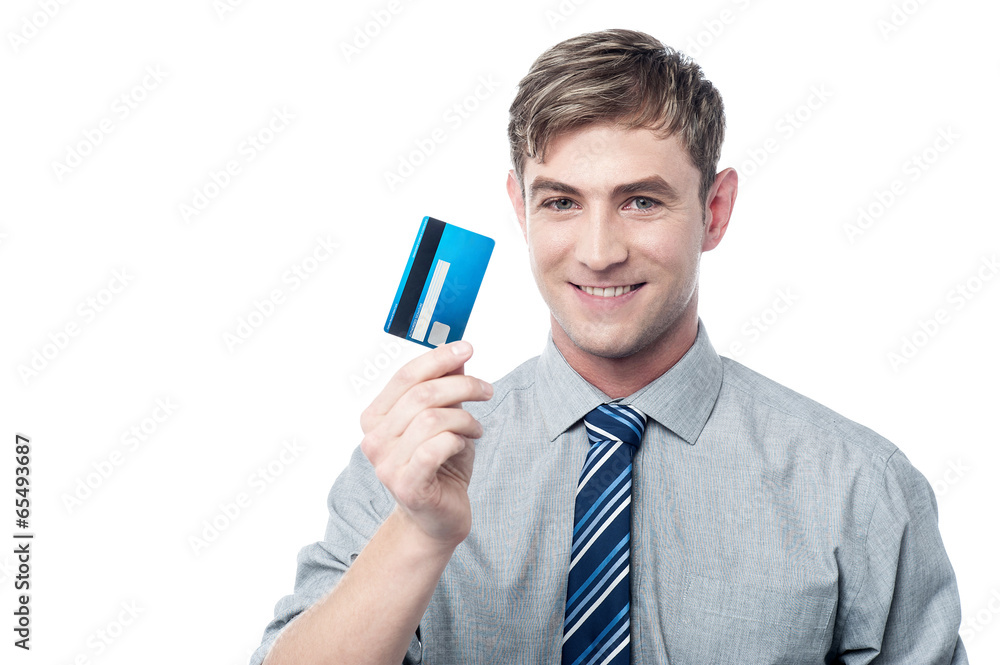 Cheerful young executive holding credit card Cheerful young executive holding credit card
