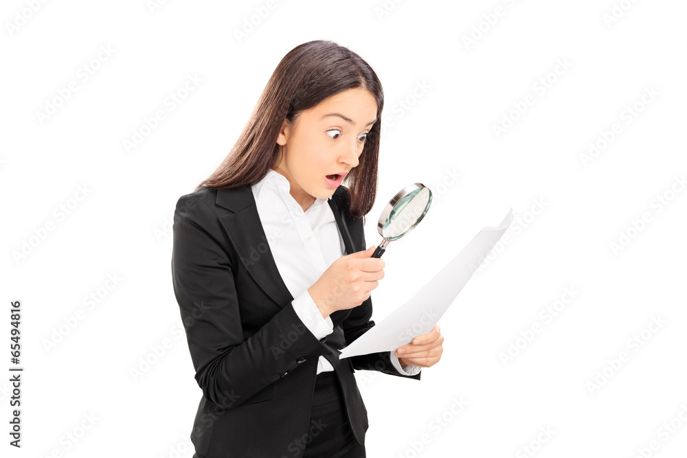 Shocked woman looking at document with scrutiny Shocked woman looking at document with scrutiny
