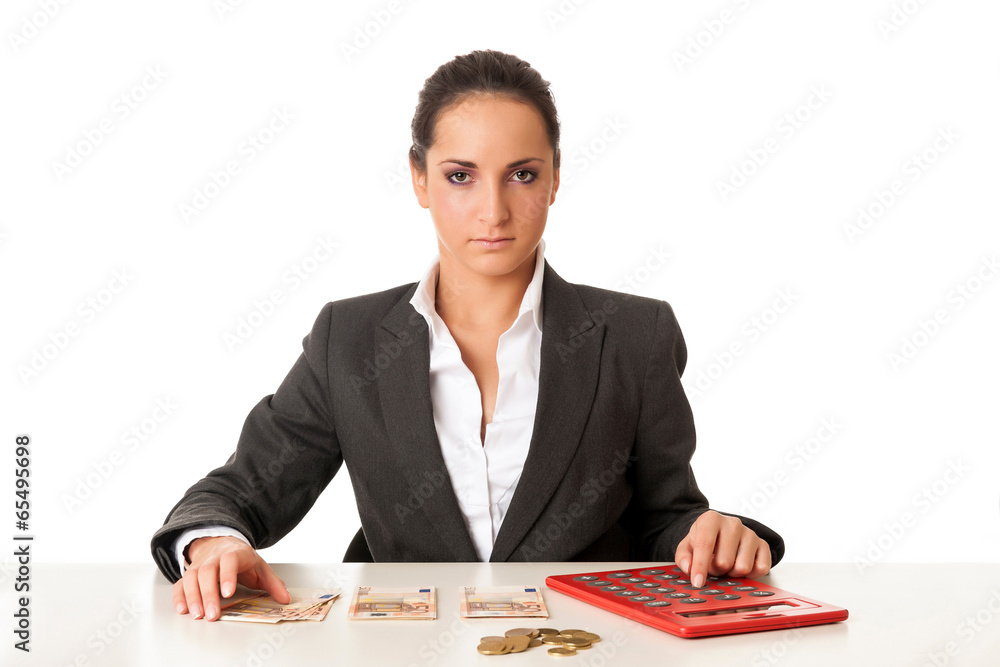 Young businesswoman calculating savings against white background Young businesswoman calculating savings against white background