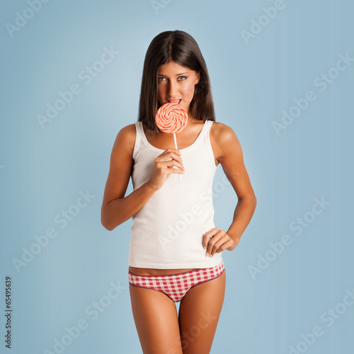Tableau sur toile Happy woman portrait with lollipop against colorful blue backgro