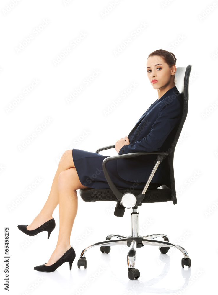 Business woman sitting in chair. Business woman sitting in chair.