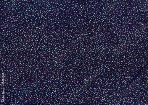 Texture of dark blue cloth with silver and blue sequins as backg