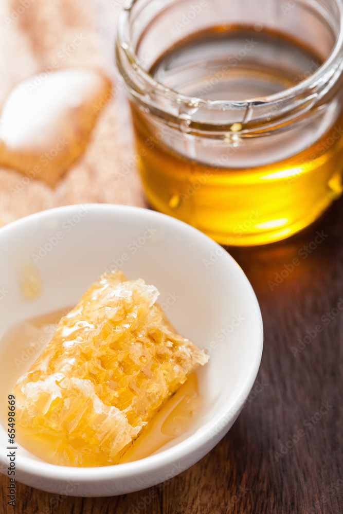 honeycomb and honey jar on wooden background honeycomb and honey jar on wooden background