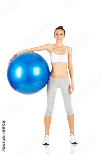 Fitness girl holding pilates ball