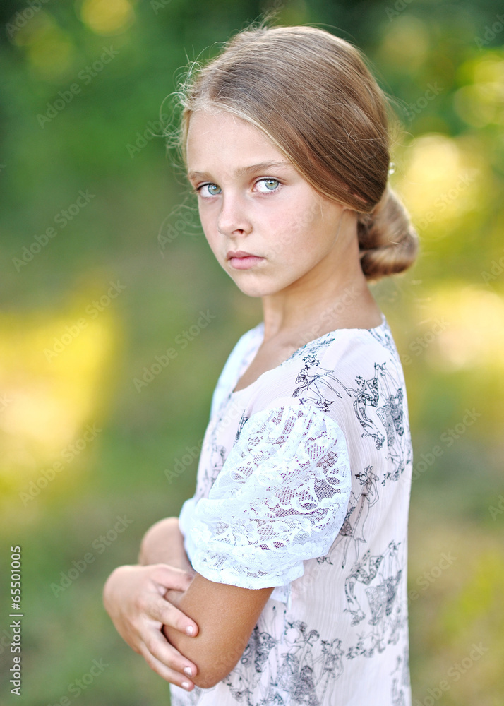 Fototapeta premium portrait of little girl outdoors in summer