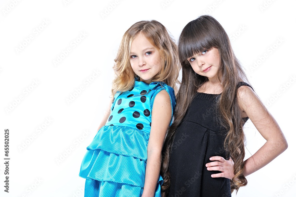 portrait of two beautiful young girlfriends in studio portrait of two beautiful young girlfriends in studio