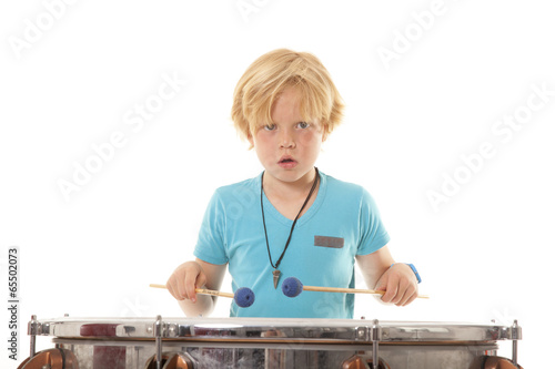 young boy playing kettledrum