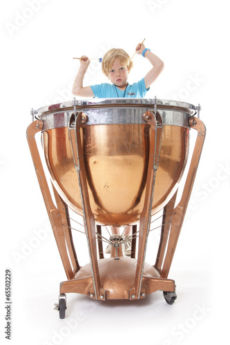 young boy playing kettledrum