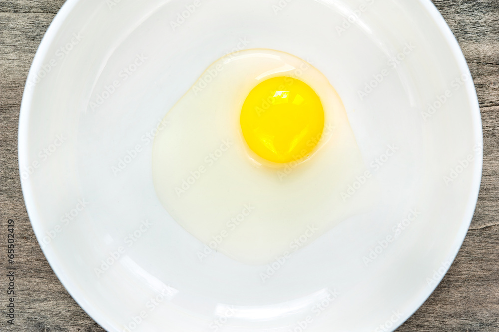 Quail eggs yellow yolk in white porcelain bowl. Closeup. Quail eggs yellow yolk in white porcelain bowl. Closeup.