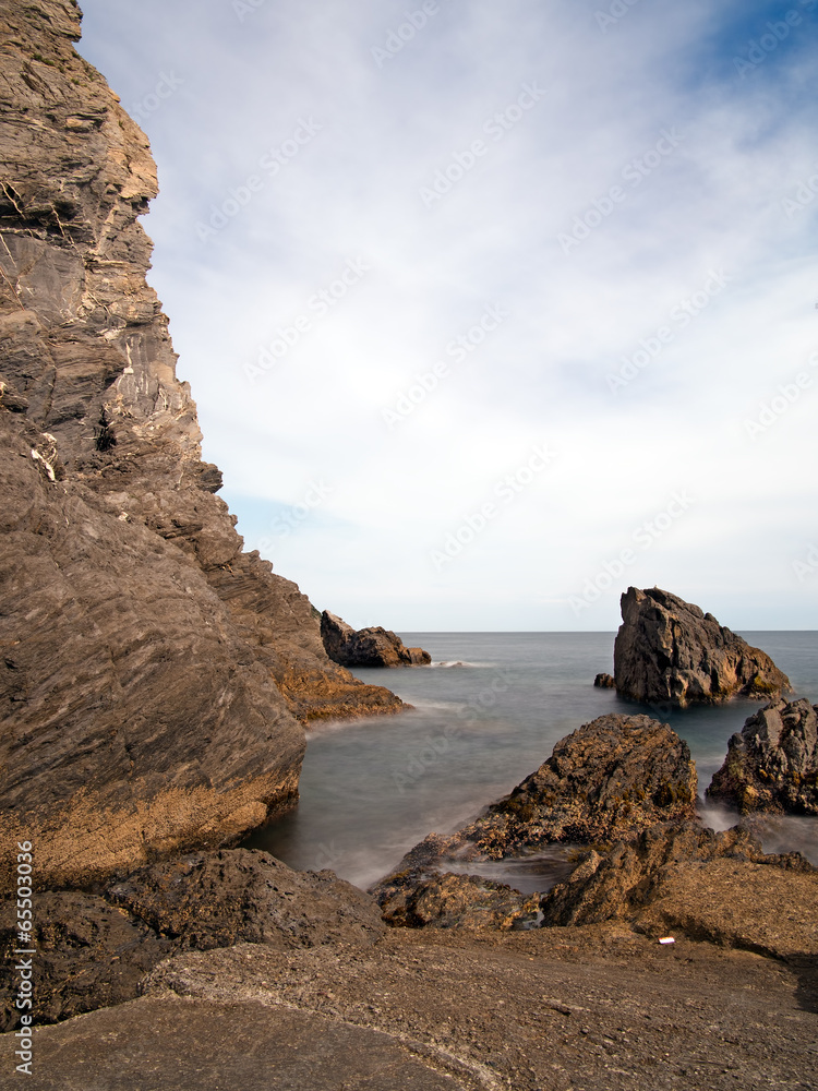 Rocky shore, coast with rocks and silky smooth sea water effect.