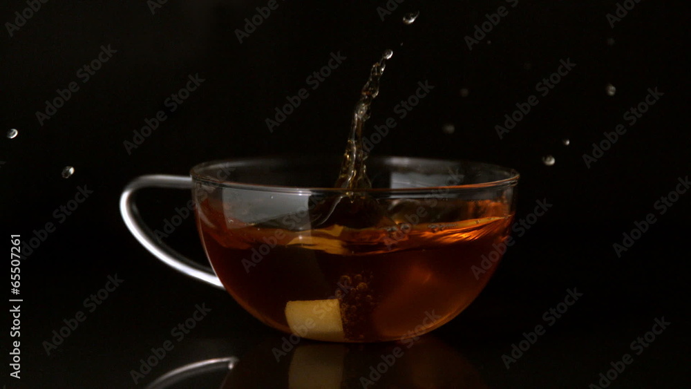 Sugar cube falling into cup of tea Sugar cube falling into cup of tea