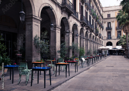 street cafe with colorful tables and chairs #65509058