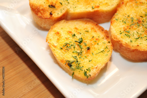 Fresh Baked Garlic Bread Served on a White Plate