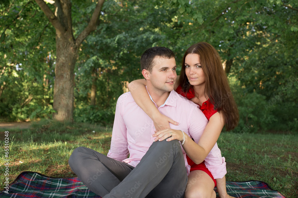 Naklejka premium Happy Family Outdoor. Smiling Man and Woman relaxing in Park.