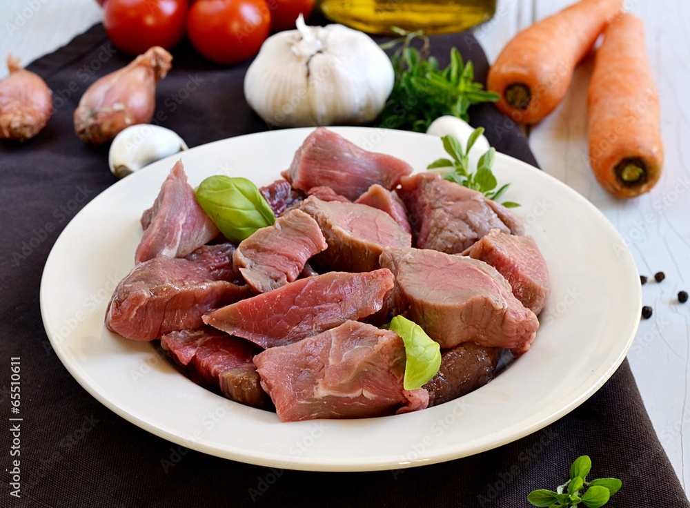 Raw beef for boeuf bourguignon with vegetables