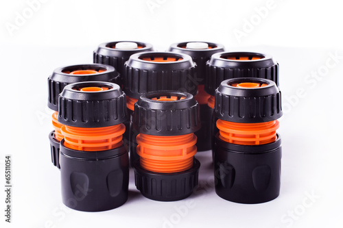 Adapter for connection of a garden hose with watering system