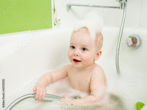 baby toddler taking bath in...