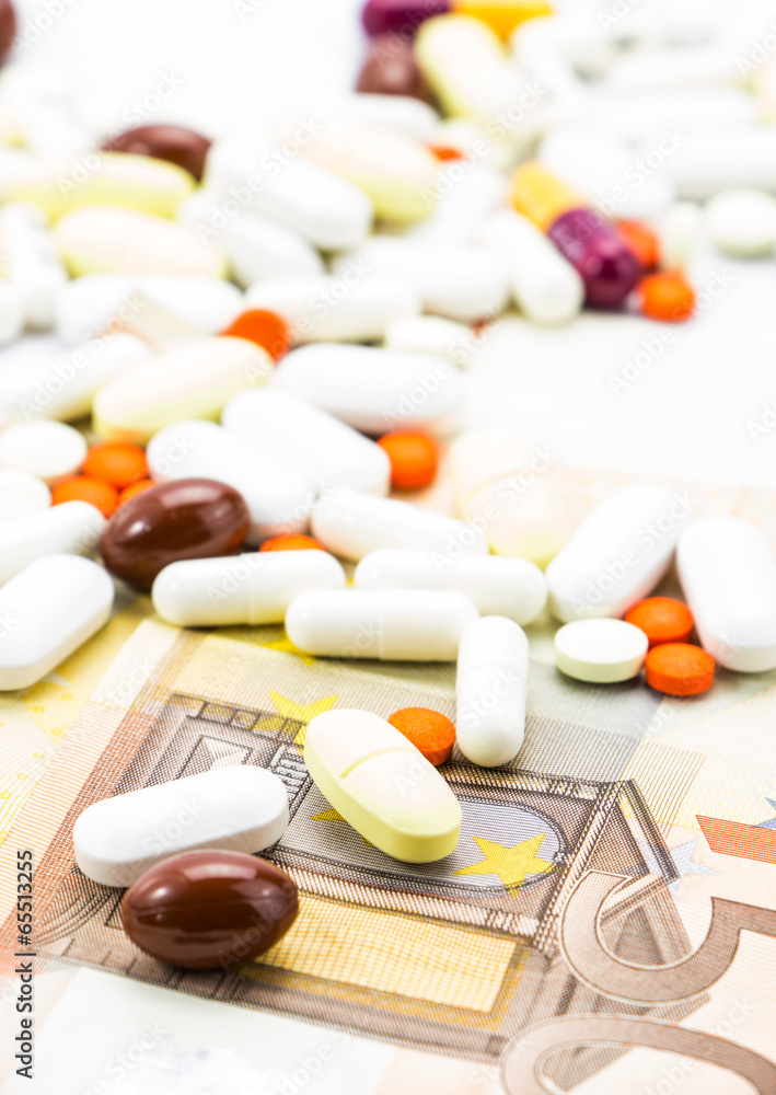 Pile of pills and banknotes closeup Pile of pills and banknotes closeup