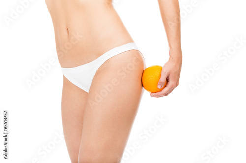 woman hip legs, belly girl holding an orange