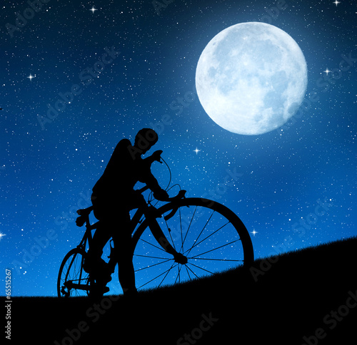 silhouette of the cyclist on a road bike in night