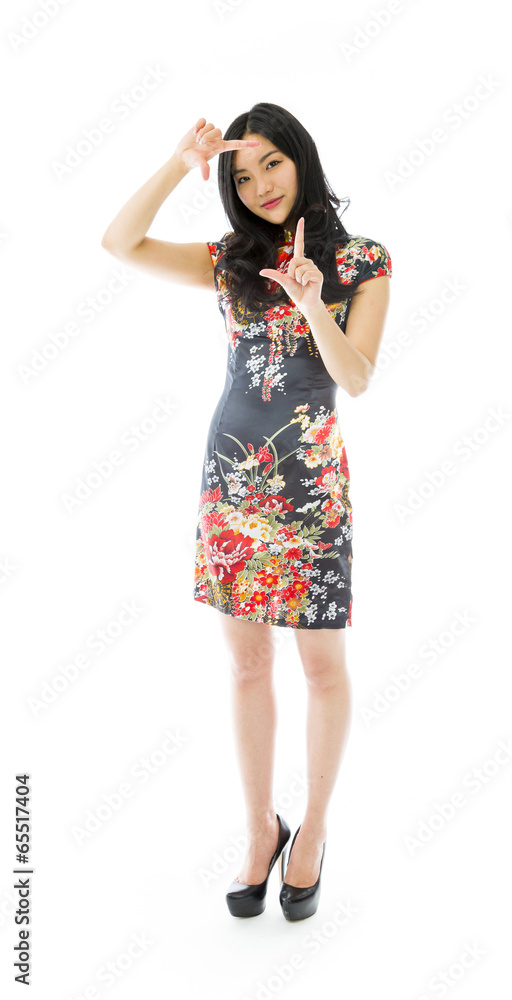 Asian young woman looking through finger frame Asian young woman looking through finger frame