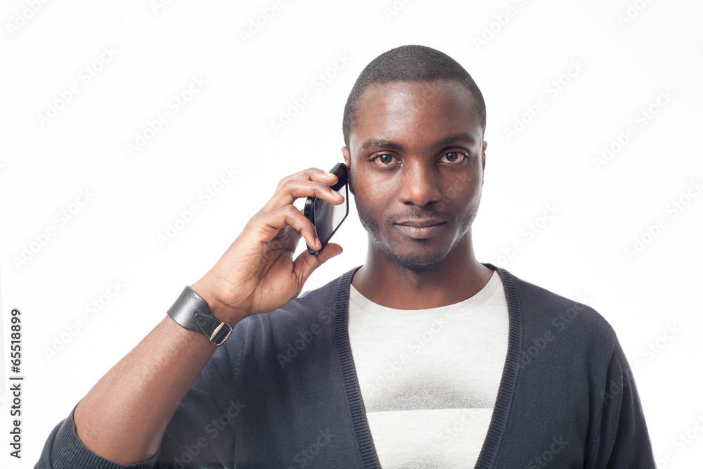 Casual dressed black man at the phone. Isolated on white. Casual dressed black man at the phone. Isolated on white.