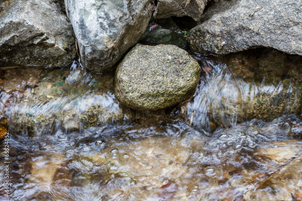 Stones with water stream flowing between Stones with water stream flowing between
