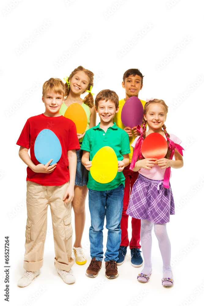 Happy kids holding egg shape colourful cards Happy kids holding egg shape colourful cards