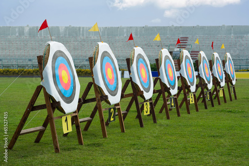Series of archery clear targets in green field photo