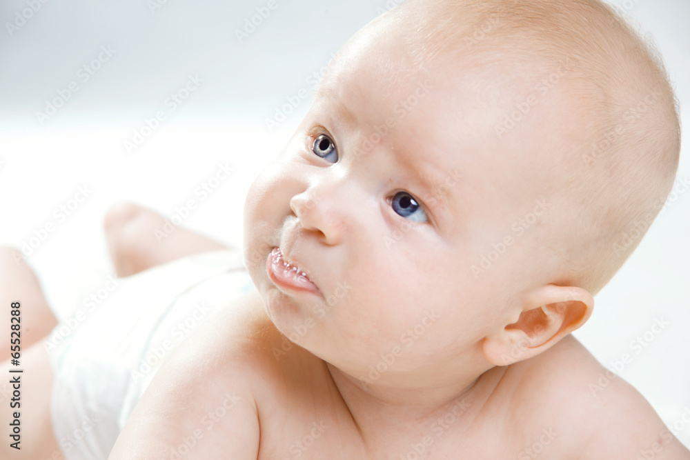 Portrait of Baby boy is hiding under the white blanket Portrait of Baby boy is hiding under the white blanket