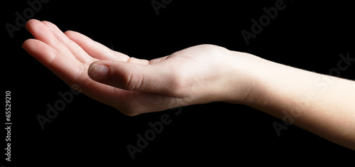 Slika na platnu Human hand on black background
