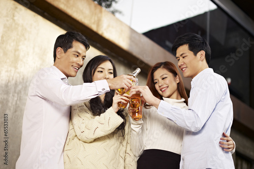 Photography young people celebrating with beer