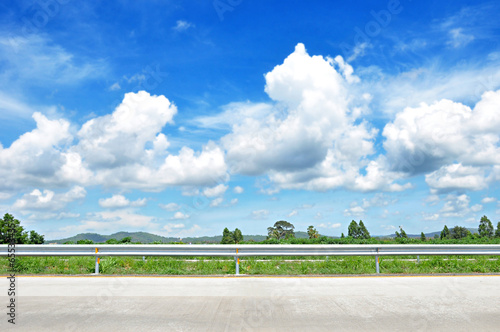 Beautiful roadside view with green nature and cloudy blue sky  b photo